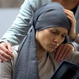 Woman with cancer looking at x-ray